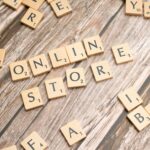 Scrabble tiles spelling 'online store' on a rustic wooden background.