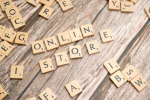 Scrabble tiles spelling 'online store' on a rustic wooden background.